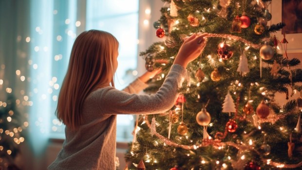 Girl decorating tree for Christmas